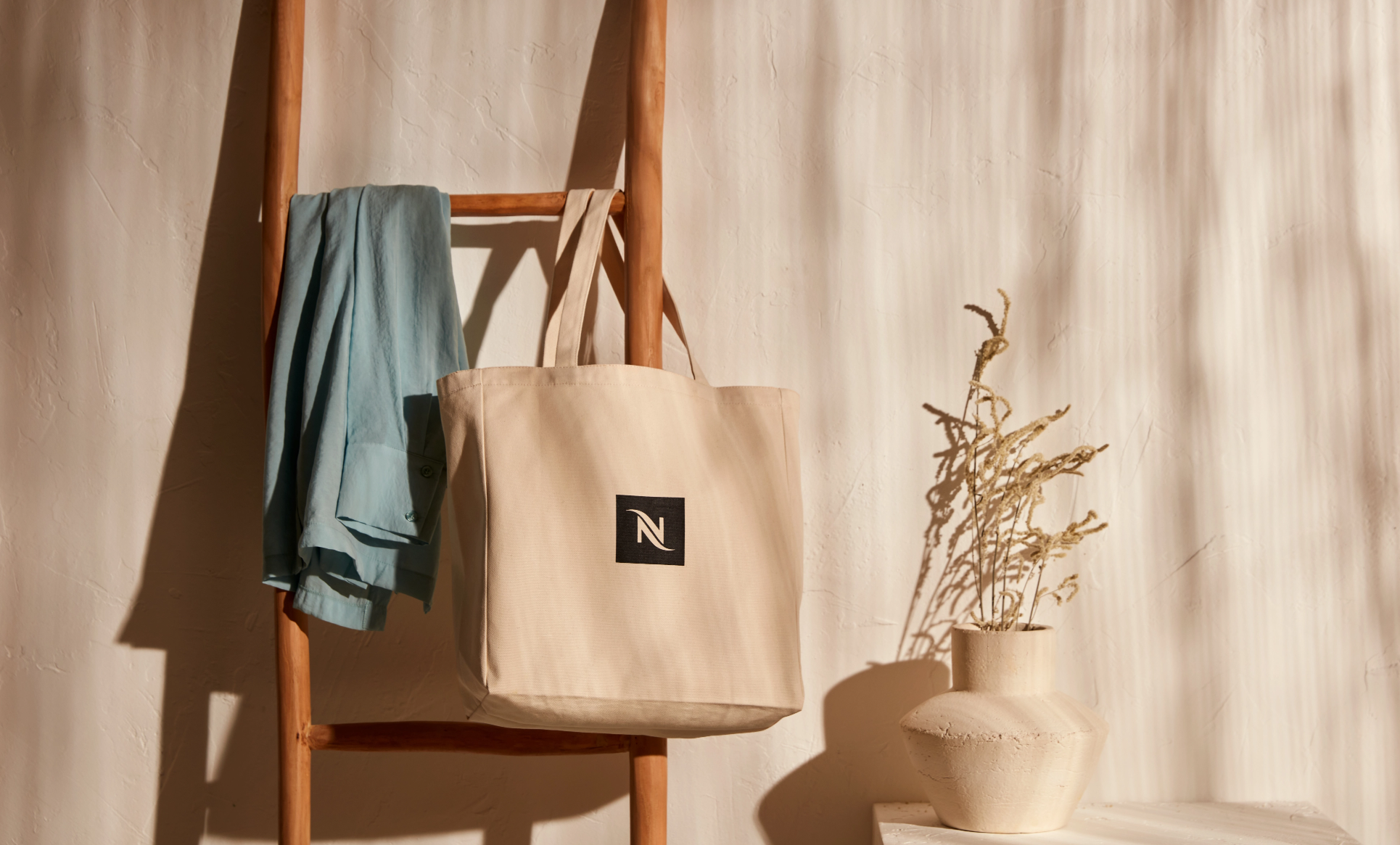 Beige branded Nespresso bag on table